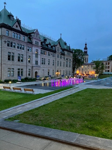 Picture of park and old building in Old Town Quebec at dusk.